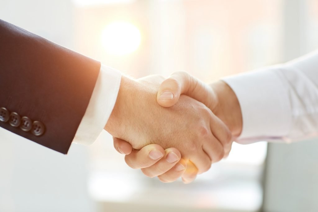 Business partners shaking hands after negotiation